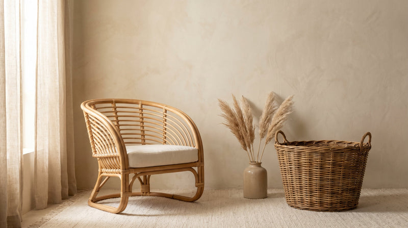 Fauteuil en rotin et panier en osier côte à côte dans un intérieur méditerranéen aux tons beige